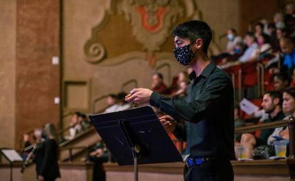 School of Music and Dance student conducts piece at Winter at the Balboa.