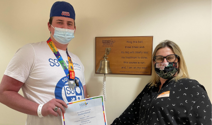 Sam Macarah ringing the bell after completing chemotherapy.